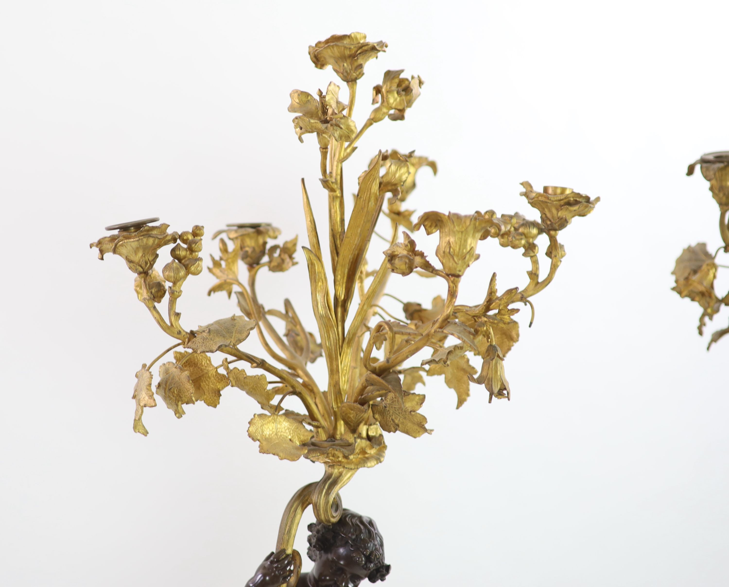 A pair of 19th century French bronze and ormolu six light candelabra, W.27cm H.109cm